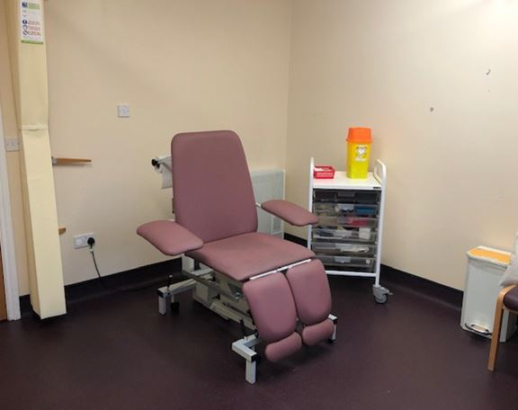a bedroom with a desk and chair in a room
