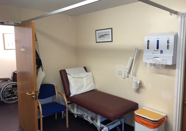 a bedroom with a bed and desk in a small room