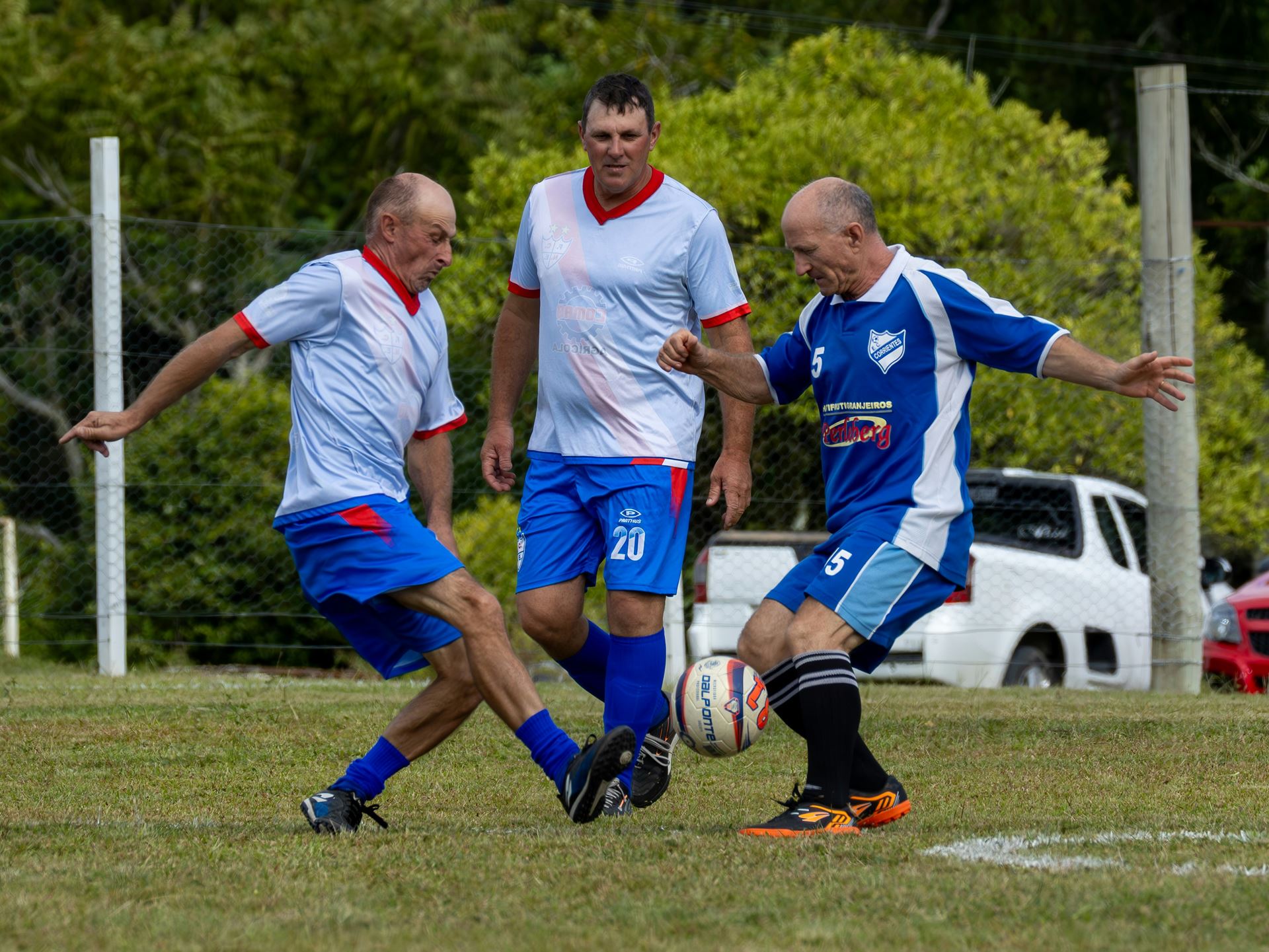 Three men playing football