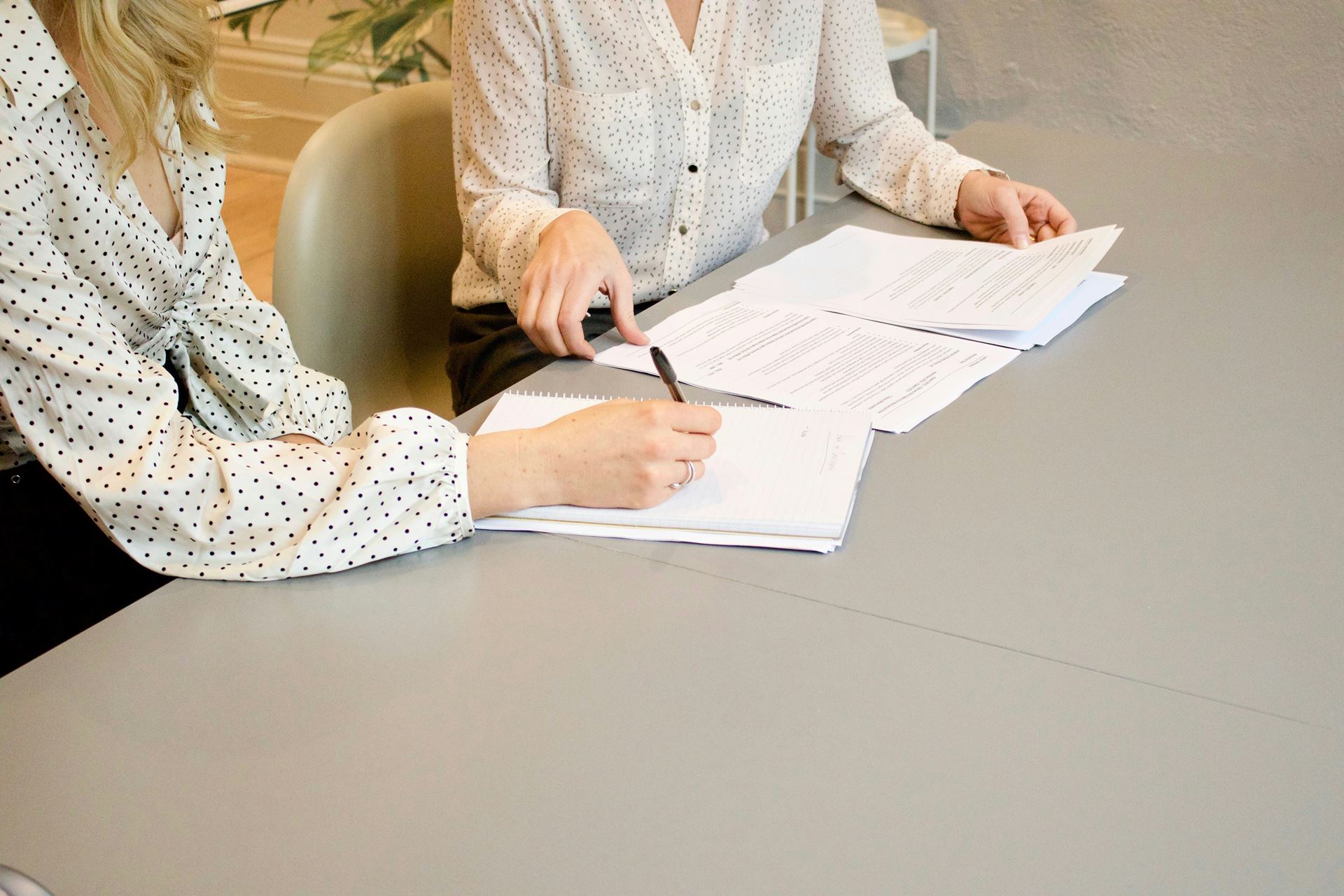 a man and a woman sat at a table reviewing documents