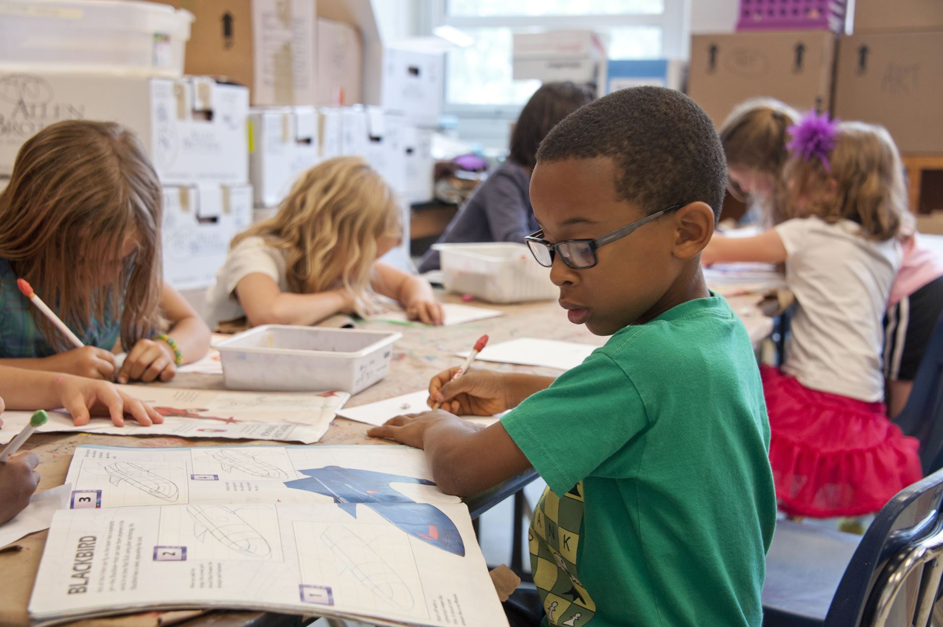 a group of children sat at a table in school